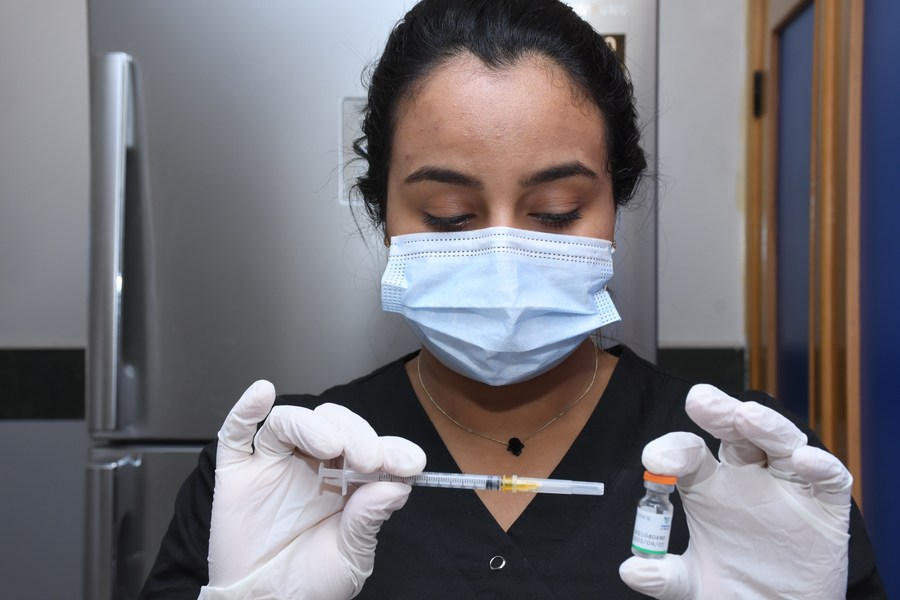 A medical worker prepares to administer a dose of China's Sinopharm COVID-19 vaccine in Sale