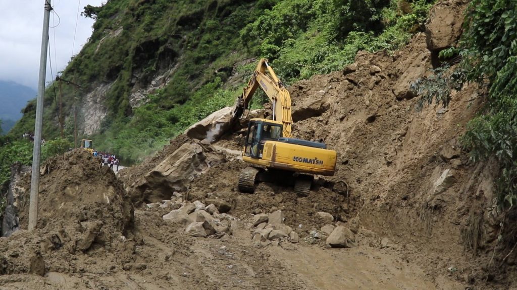 Landslide while digging road: Three missing, dozer buried