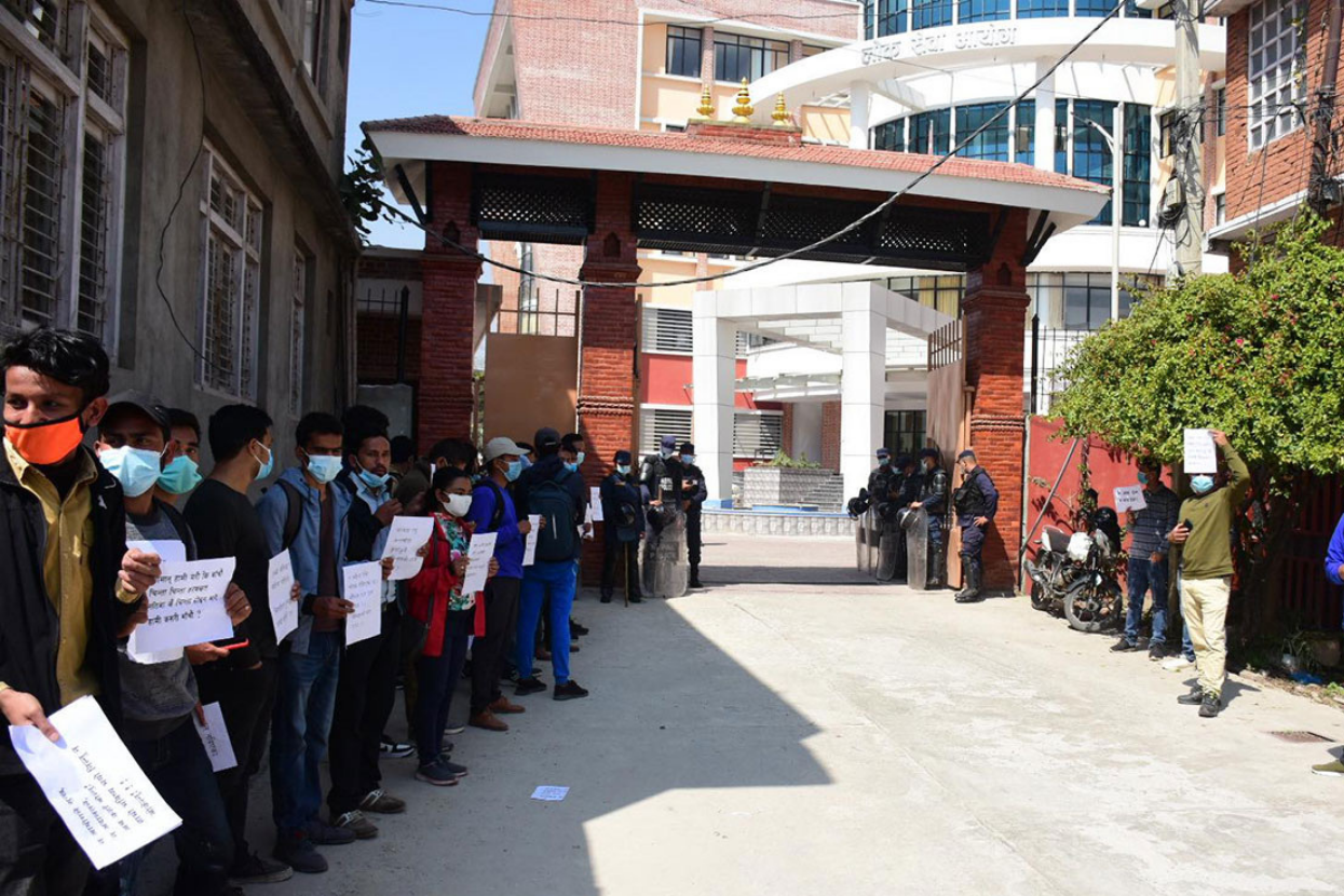 Candidates who have passed the written examination staged a sit-in protest