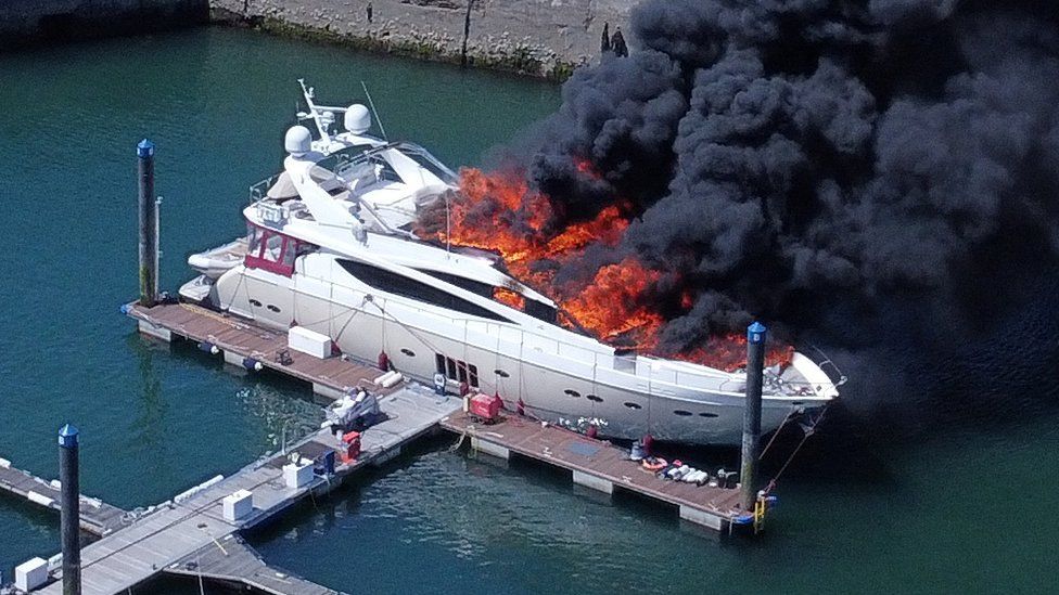 Superyacht sinks in Torquay harbour after large fire