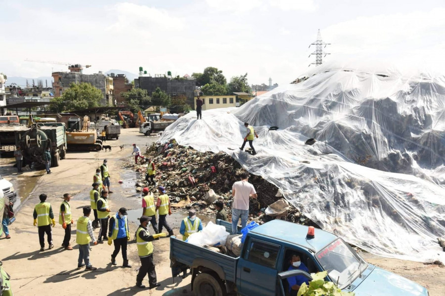 City covers waste pile in plastic after rains damage road to Banchare Danda