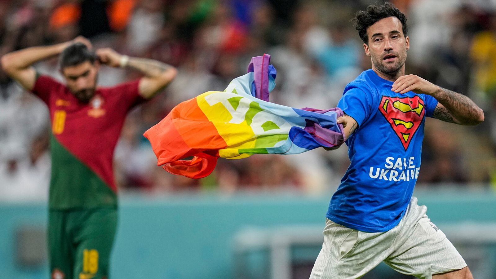 Pitch invader with rainbow flag halts play in Portugal-Uruguay game