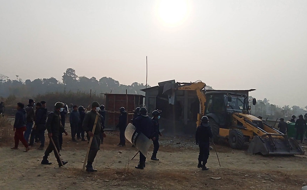 Locals pelt stones at Harak Sampang as he drives a dozer in Dharan