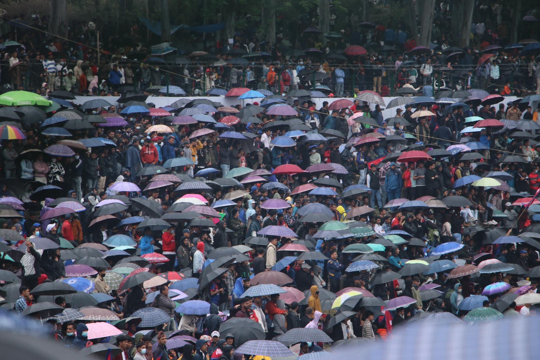 Cricket craze in Kirtipur: No drop in spectator attendance despite rain, waiting the match to be resumed (photos)