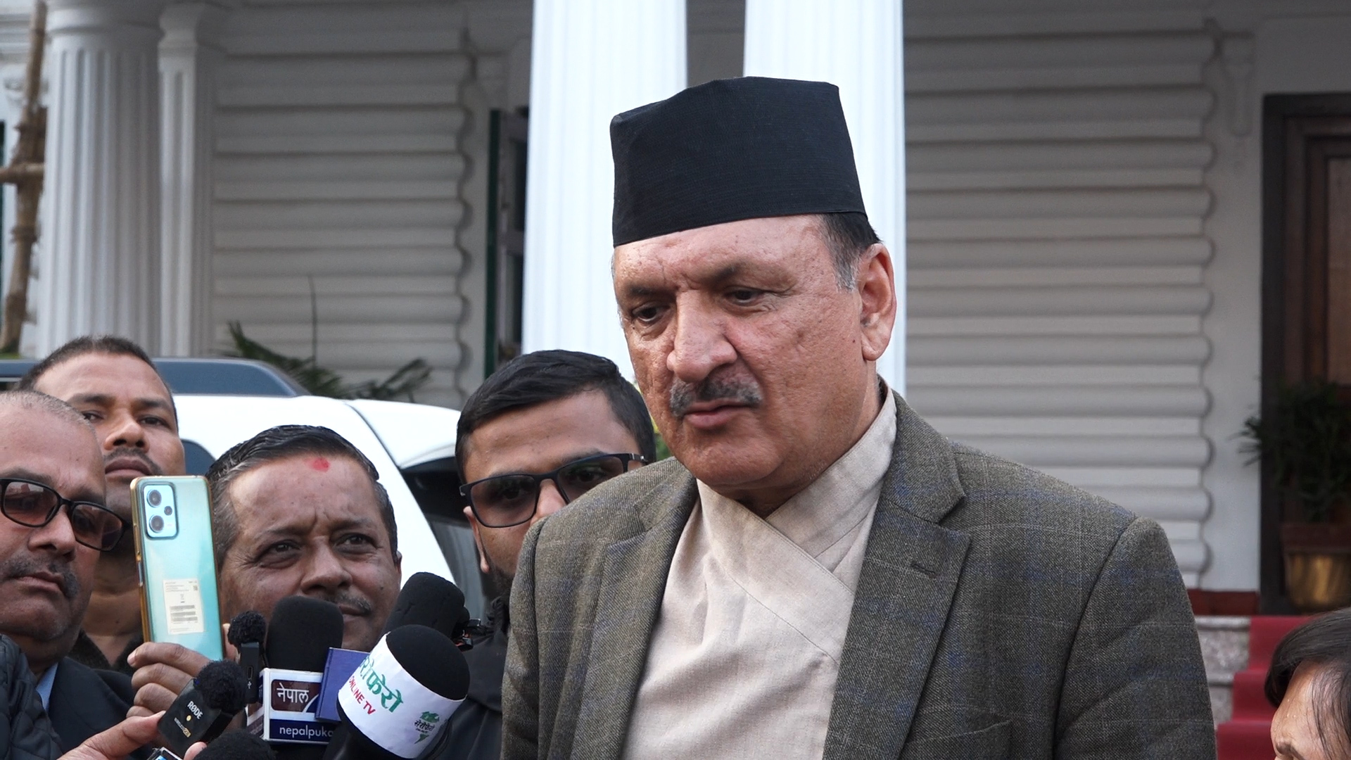 Finance & Law Ministers exit Deuba residence covering the flag