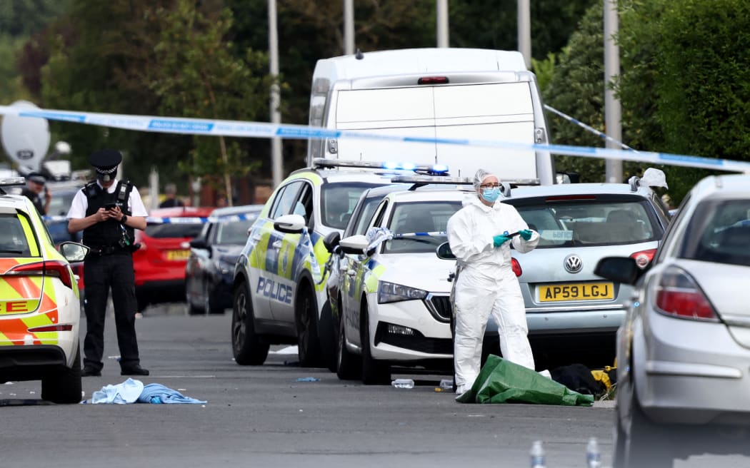 UK police question teen held after deadly mass stabbings