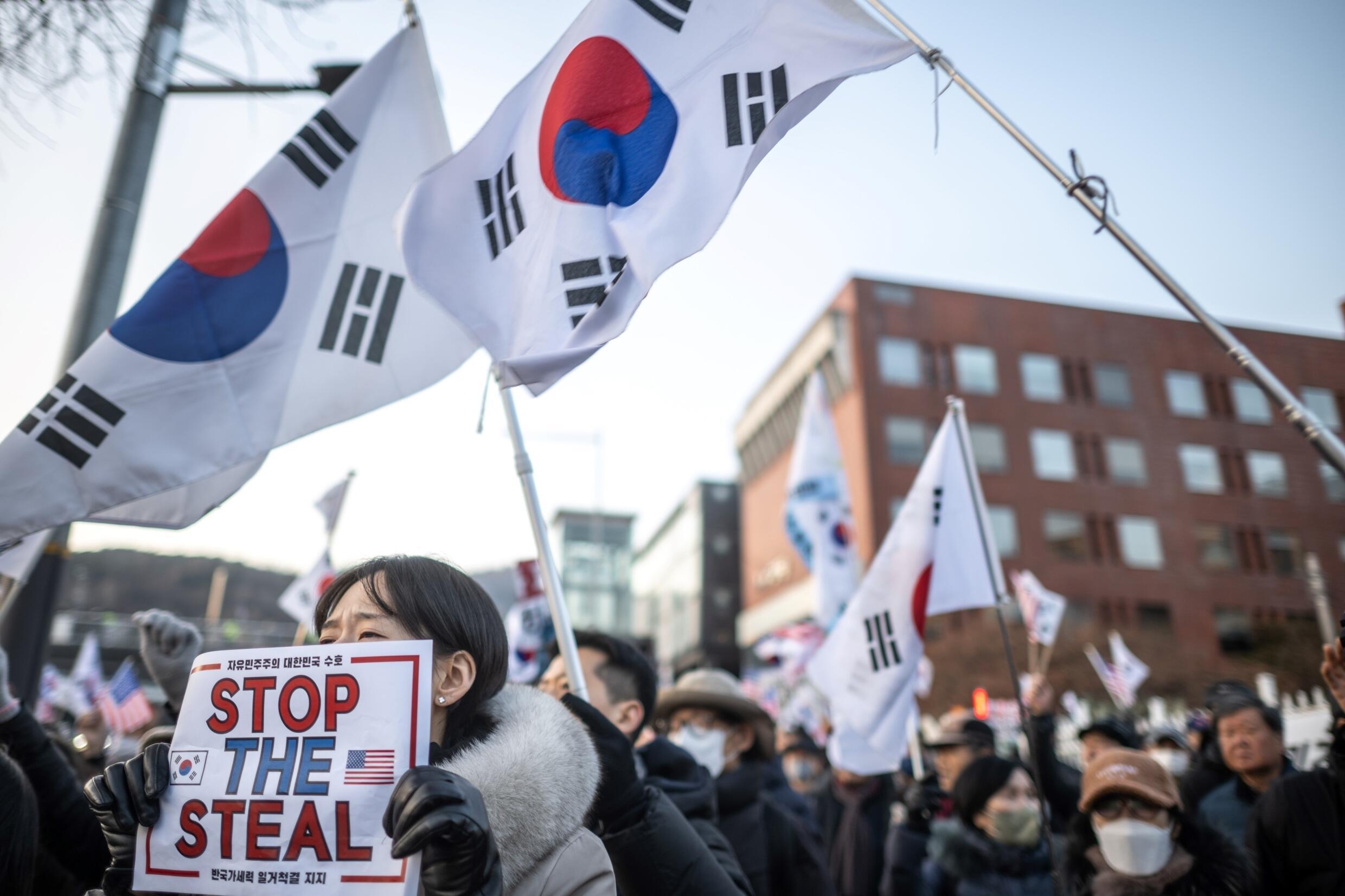 South Korea’s impeached president resists arrest over martial law bid