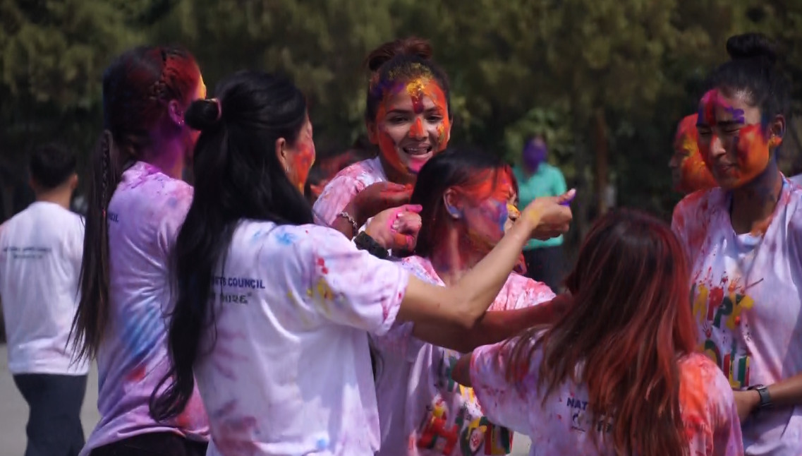 Volleyball players celebrate holi with colors & joy