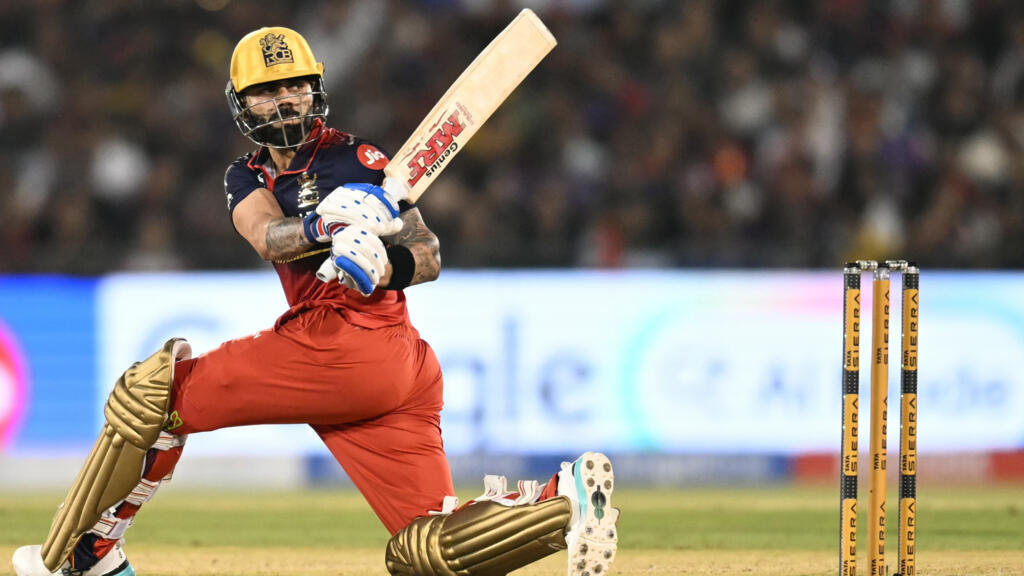 Kohli century powers RCB to top of IPL table
